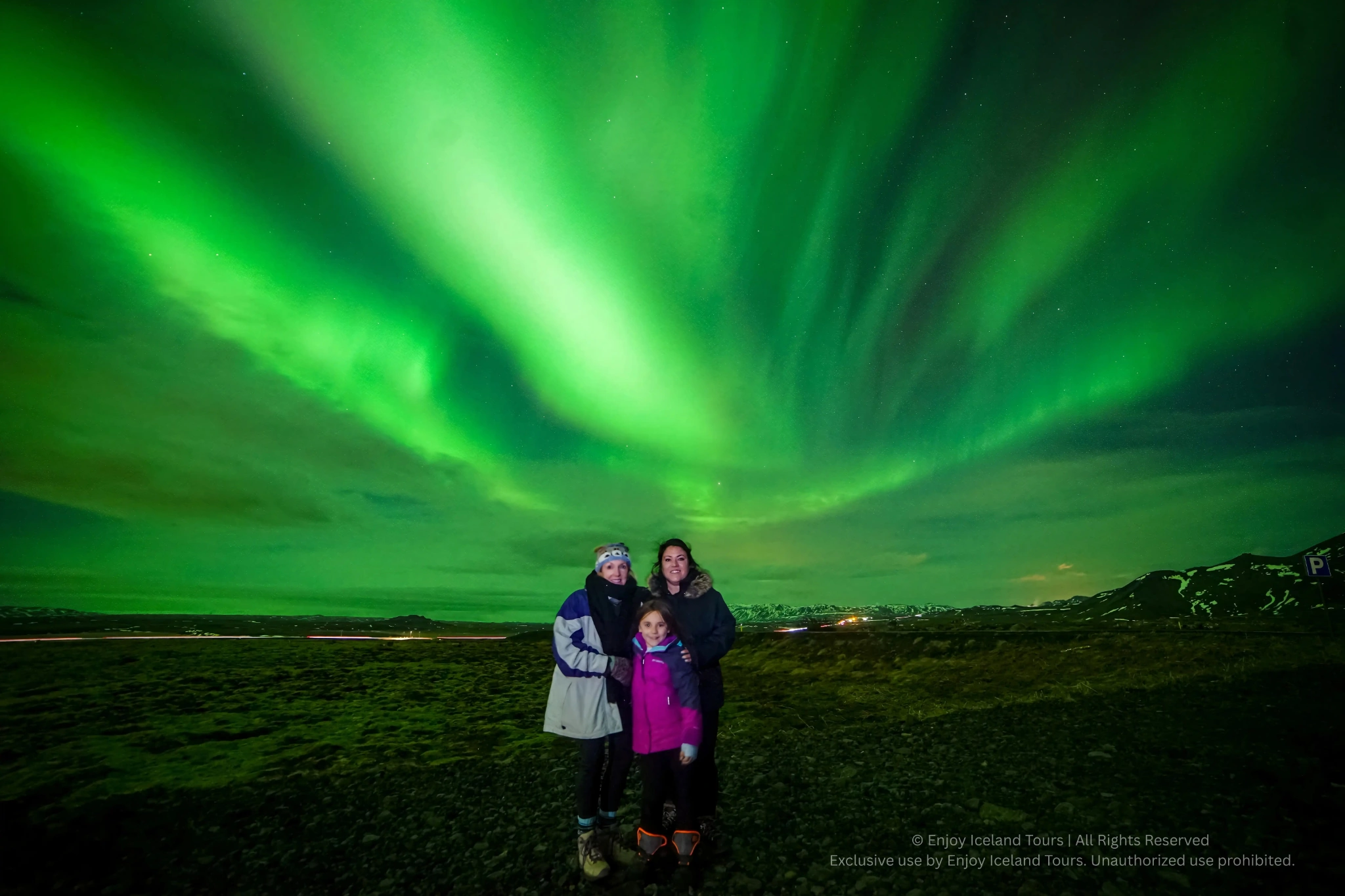 Family enjoying a private Northern Lights tour in Iceland
