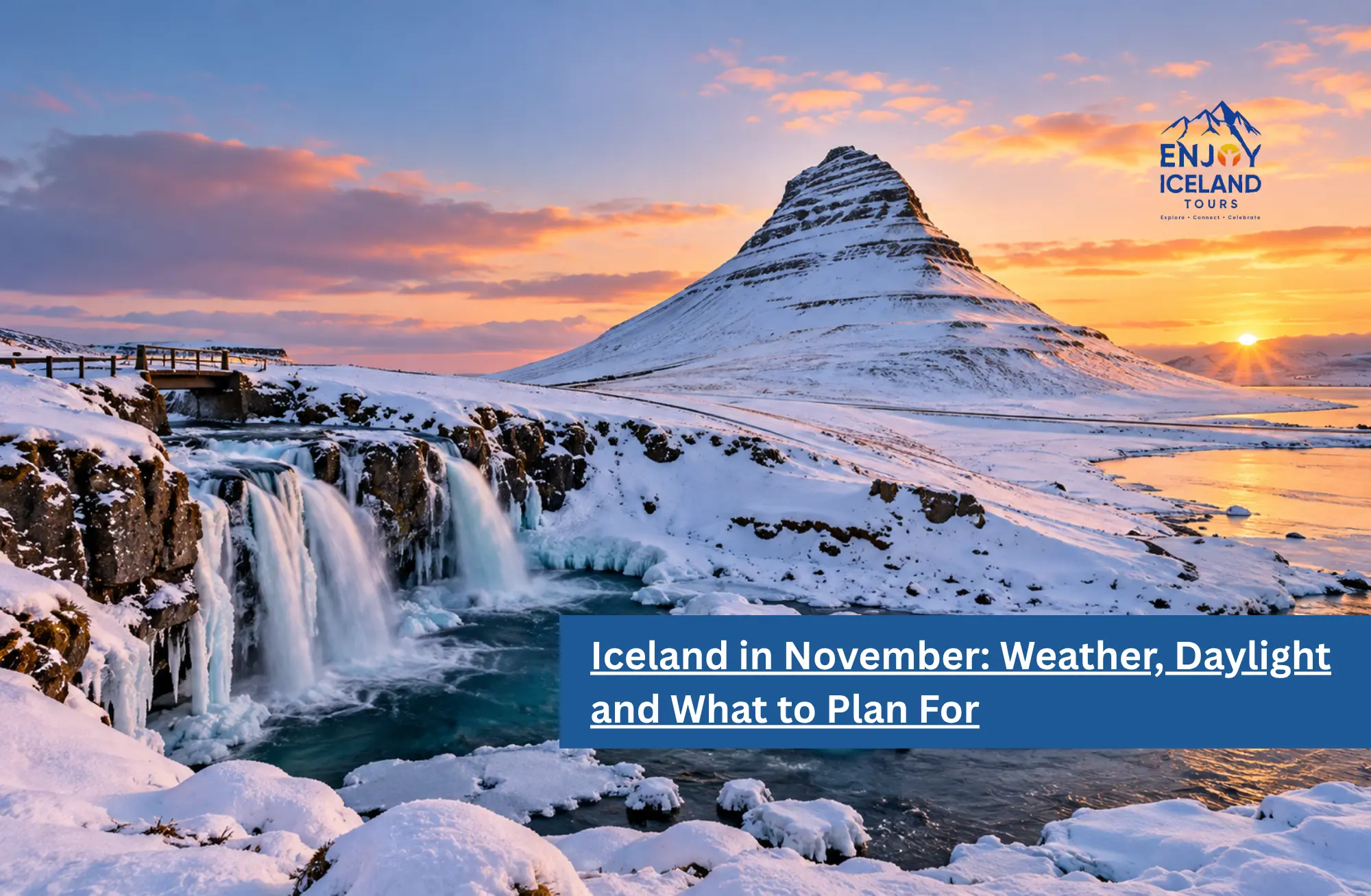 Kirkjufell mountain and a frozen waterfall in Iceland at sunset with snow and orange clouds