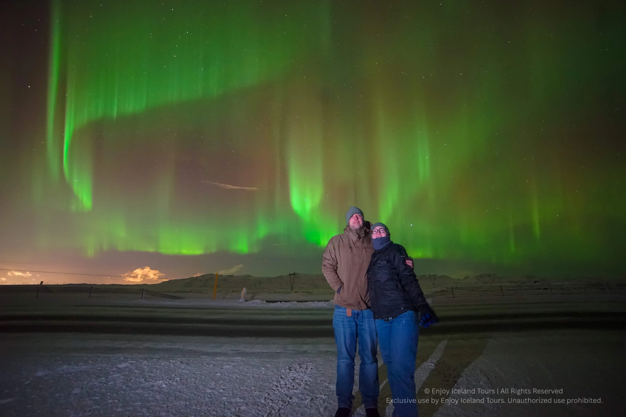 Couple embracing under the Northern Lights in Iceland