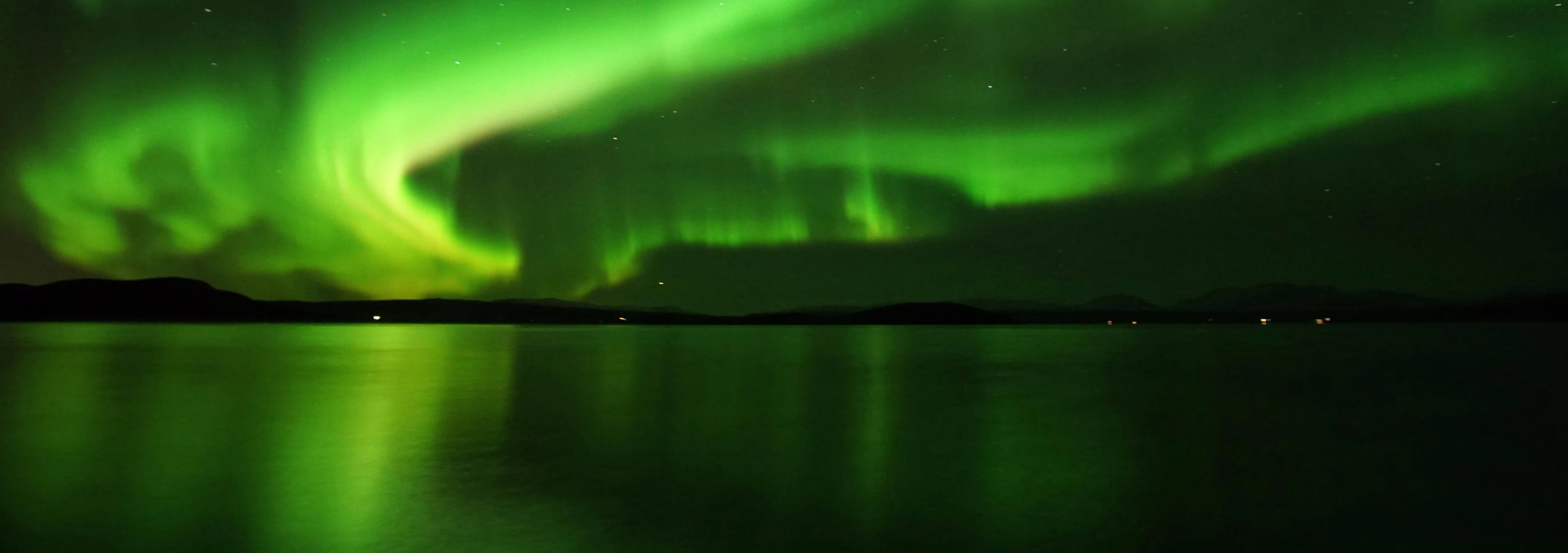 Aurora Borealis dancing over Icelandic mountains